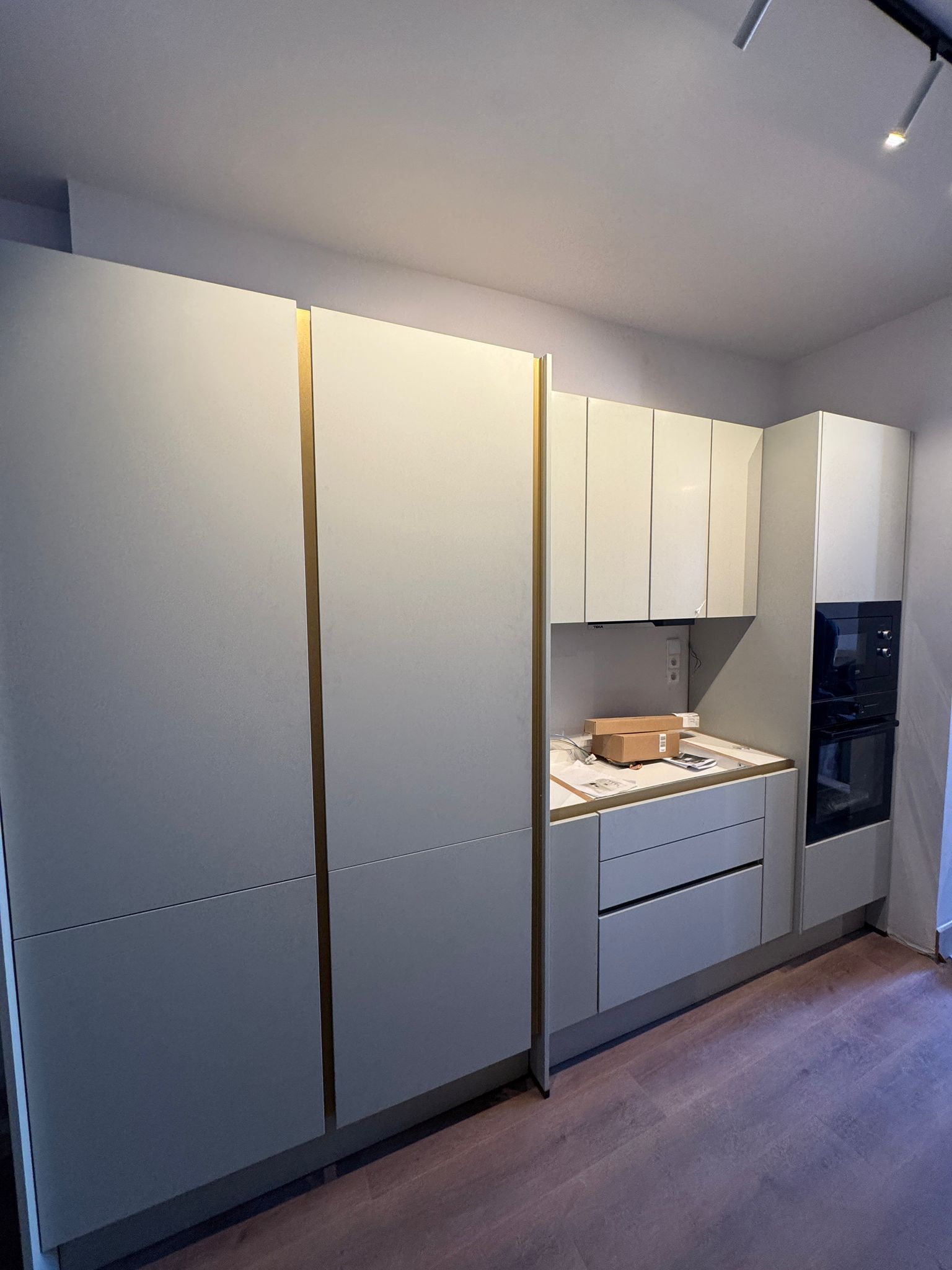 White bespoke kitchen with gold handles
